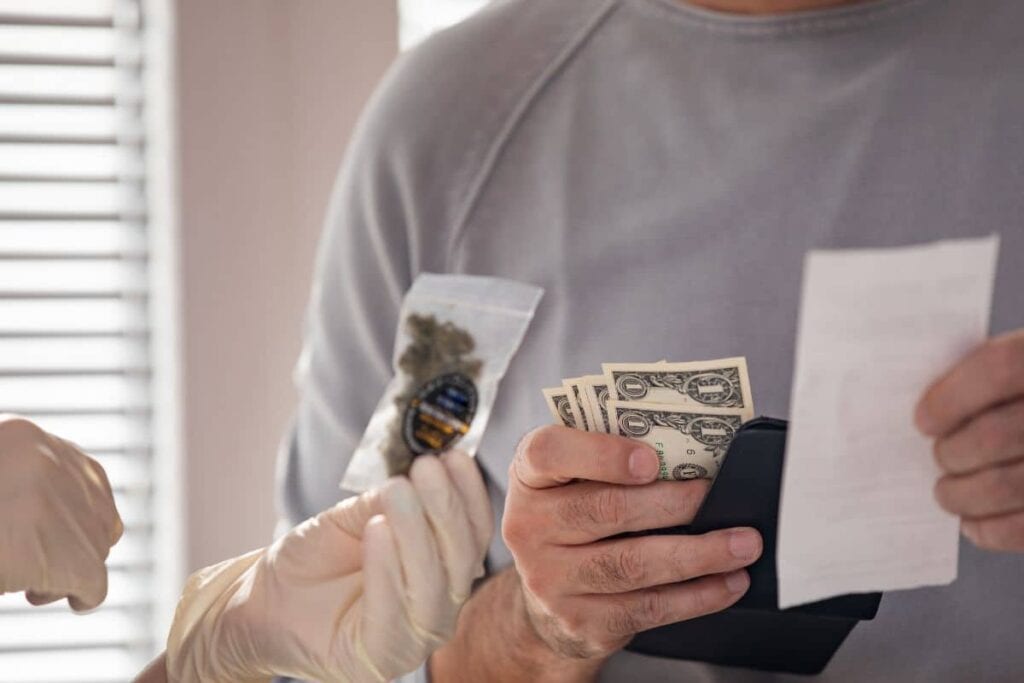 A man is holding money and a woman is holding a credit card, while discussing the legality of THCa in Pennsylvania.