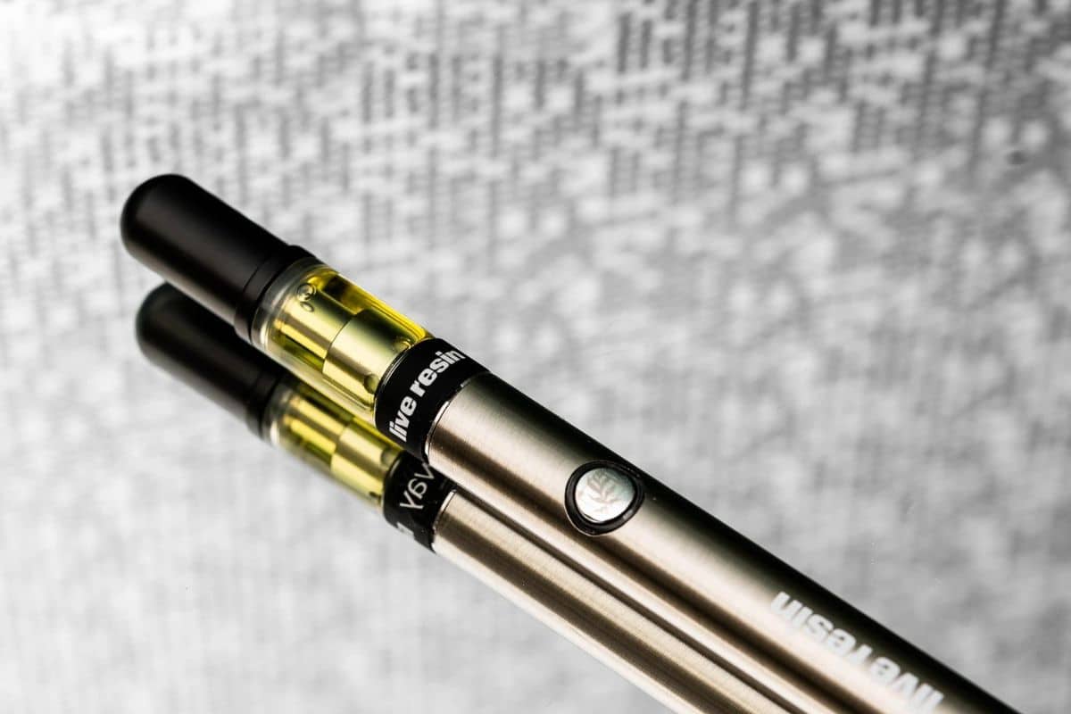 Two 510 thread batteries, used for e-cigarettes, sitting on top of each other.