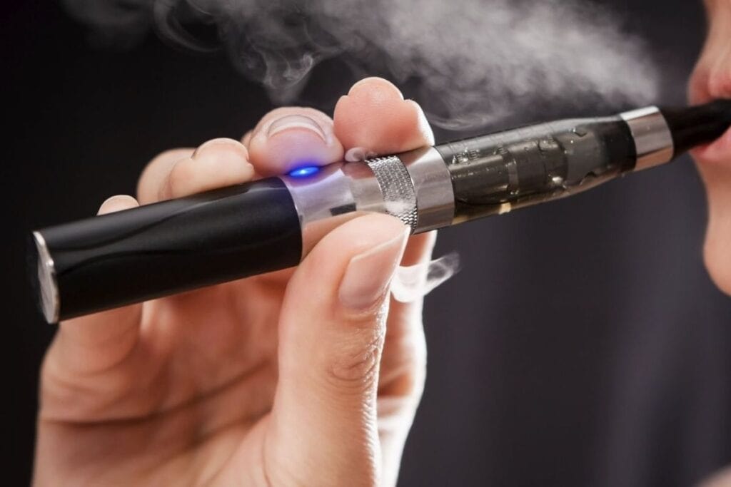A lady using a vape cartridge after preheating it for an optimal experience