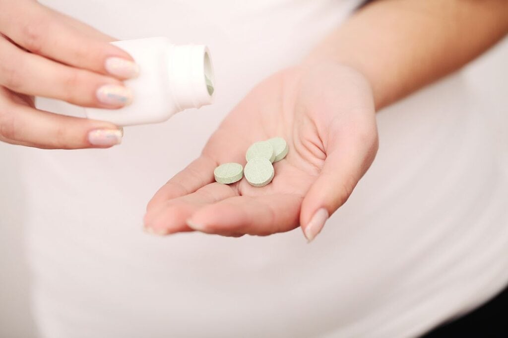 A lady taking kanna infused tablet for relaxation