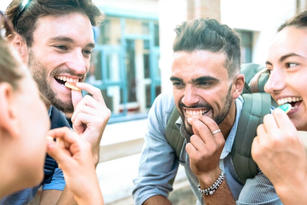 Friends enjoying CBD gummies together on holiday