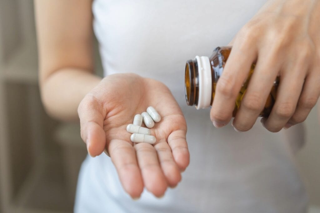 A lady displaying kava capsules supplement